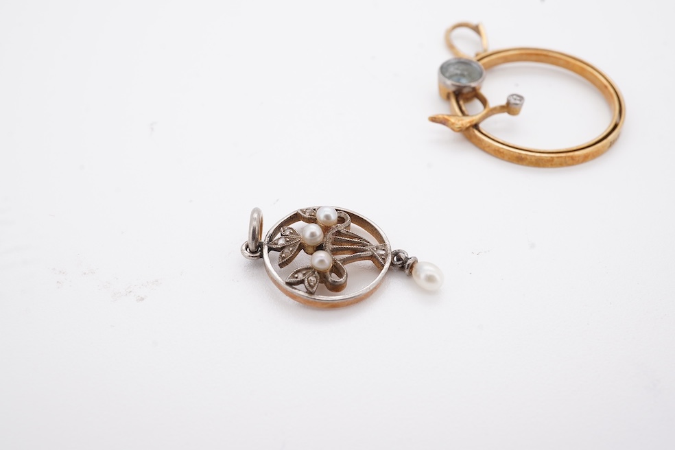 An early 20th century yellow metal, diamond chip and seed pearl set drop pendant, overall 23mm, together with a similar yellow metal, diamond and gem set open work pendant, diameter 20mm, gross weight 3.7 grams. Conditio